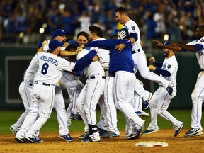 The Kansas City Royals celebrate after catcher Salvador Perez hits a 12th inning walk-off single against the Oakland Athletics during the American League wild card game at Kauffman Stadium in Kansas City, Sept. 30, 2014. (PETER G. AIKEN/USA Today)