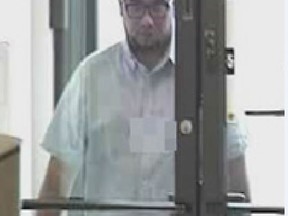 Winnipeg police are looking for this man in connection with bank thefts at two city financial institutions from July 2014. (POLICE HANDOUT PHOTO)