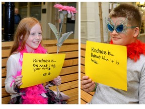 From left to right: Emma Bradley, Christopher Bilyea and Husna Barakzai, all Gr. 6 pupils at Eagle Heights public school, hold signs with their definition of what happiness is to them. The class was helping launch this year's 1,000 Acts of Kindness challenge at Cherryhill Village Mall on Wednesday. 
MORRIS LAMONT / THE LONDON FREE PRESS / QMI AGENC