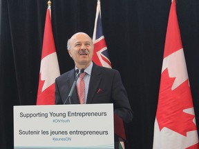 Reza Moridi, provincial minister of research and innovation, addresses a Queen's University audience to announce funding to promote entrepreneurship and innovation on post-secondary campuses. (Michael Lea/The Whig-Standard