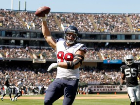Houston Texans defensive end J.J. Watt reacts after catching a touchdown pass against the Oakland Raiders at O.co Coliseum on September 14, 2014. (Cary Edmondson/USA TODAY Sports)