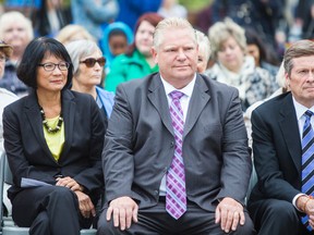 Toronto mayoral candidates Olivia Chow (from left), Doug Ford and John Tory during the CARP flag raising ceremony in honour of National Seniors Day at Toronto City Hall on Wednesday October 1, 2014. (Ernest Doroszuk/Toronto Sun)