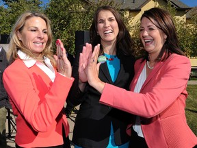 School trustee and former CBE chair Sheila Taylor (M) high-fives Kathy Macdonald (L) and Danielle Smith (R) after she announced she was running for the Wildrose in Calgary West  on Wednesday October 1, 2014. The announcement was made on Signal Hill in SW Calgary, Alta. Stuart Dryden/Calgary Sun/QMI Agency