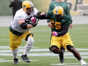 Elie Ngoyi, right, shown here practising with Simeon Rottier earlier this season, is moving to the defensive tackle position while two Canadian tackles are out with injuries. (David Bloom, Edmonton Sun)