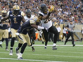 Mossis Madu runs in for a touchdown against the Blue Bombers last week. (Kevin King/QMI Agency)