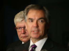 Dave Hancock stands behind Premier Jim Prentice as he speaks to the media at Government House, in Edmonton Alta., on Monday Sept. 8, 2014. David Bloom/Edmonton Sun/QMI Agency