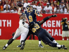 St. Louis Rams quarterback Austin Davis throws the ball as Tampa Bay Buccaneers defensive tackle Clinton McDonald rushes and  Rams guard Davin Joseph blocks at Raymond James Stadium on September 14, 2014. (Kim Klement/USA TODAY Sports)