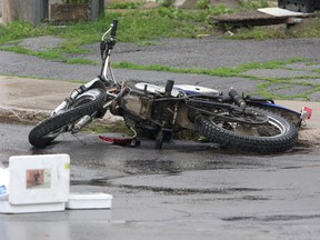 A mangled motorcycle that was involved in a collision with a minivan at the corner of Patrick and John streets on July 8. (Ian MacAlpine/The Whig-Standard)