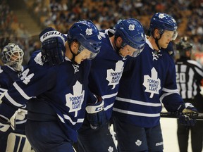 Maple Leafs defenceman Cody Franson is helped off the ice by teammates after crashing into the boards at the Air Canada Centre on Sunday night. (USA TODAY Sports)