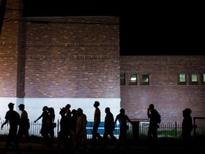 Protesters march in front of the police department during a rally in Ferguson, Missouri, September 26, 2014. (REUTERS/Whitney Curtis)