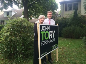 John Tory and former Liberal MPP Donna Cansfield install a Tory campaign sign on her front lawn on Thursday, Oct. 2, 2014. (DON PEAT/Toronto Sun)