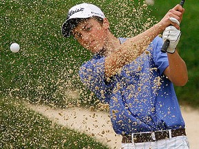 Logan Foeller of St. Theresa blasts out of a sand trap during COSSA golf championships at the Kawartha Golf and Country Club in Peterborough. (Clifford Skarstedt/Peterborough Examiner/Postmedia Network file photo