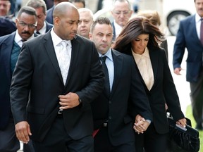 Teresa and Giuseppe "Joe" Giudice, stars of the reality television series "Real Housewives of New Jersey" hold hands as they arrive at U.S. federal court in Newark, New Jersey, October 2, 2014. The couple were appearing for a sentencing hearing after pleading guilty in March on conspiracy and bankruptcy fraud charges.   REUTERS/Mike Segar