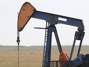 An oil derrick draws crude oil from a reserve deep underground alongside Highway 44 northwest of Edmonton. IAN KUCERAK/EDMONTON SUN FILE PHOTO
