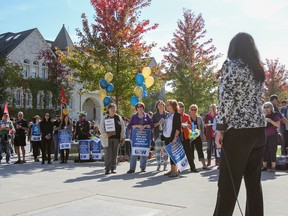 Kelly Orser, right, president of the United Steelworkers Local 2010 and 2010-01, spoke before a crowd of close to 100 people at a rally outside Richardson Hall on Thursday. (Julia McKay/The Whig-Standard)