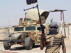 A fighter of the Islamic State of Iraq and the Levant (ISIL) stands guard at checkpoint near the city of Baiji, north of Baghdad.

REUTERS/Stringer