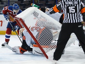 Oil Kings' Edgars Kulda (23) tries to geta puck past Medicine Hat goaltender Marek Langhamer as the  net comes off the posts during the third period of a WHL game between the Edmonton Oil Kings and the Medicine Hat Tigers at Rexall Place in Edmonton, Alta., on Tuesday, Sept. 30, 2014. The Tigers won 4-2. Ian Kucerak/Edmonton Sun/ QMI Agency