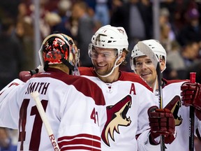Arizona Coyotes forward Martin Hanzal congratulates  goalie Mike Smith on their victory at the end of the game at Rogers Arena on September 29, 2014. (Bob Frid/USA TODAY Sports)