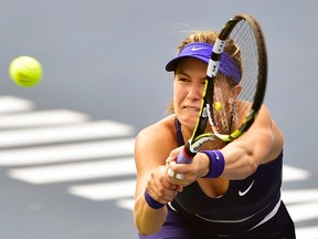 Eugenie Bouchard hits a return to Petra Kvitova during their women's singles final match at the Wuhan Open in Wuhan, China, Sept. 27, 2014. (Reuters/China Daily)