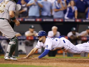 Royals’ Eric Hosmer slides safely into home to score in the 12th inning during the AL wild-card game on Tuesday in Kansas City. (AFP/PHOTO)