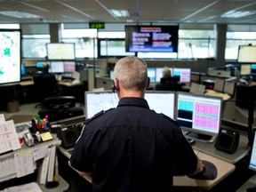 Sgt. Derek Spence works in the communications section, where 911 calls are fielded and officers dispatched, in the London police headquarters on Dundas St. Police are concerned about delays that result when people try to contact police using a Voice over Internet Protocol phone carrier. (CRAIG GLOVER/The London Free Press)