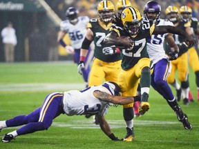 Green Bay Packers running back Eddie Lacy breaks a tackle by Minnesota Vikings safety Robert Blanton at Lambeau Field in Green Bay, Oct. 2, 2014. (BENNY SIEU/USA Today)