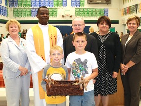 Renovations at Gregory A. Hogan Catholic School were formally recognized on Thursday. In the front row are students Dylan Towner (left) and Brody Armstrong. Behind them, from left: school board trustee Linda Ward, Father Festus Komolafe, St. Clair District Catholic Board director of education Dan Parr, principal Elena Pagotto and vice principal Liz Bujaki. CARL HNATYSHYN/ QMI AGENCY