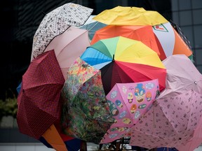 Umbrellas are set up together, symbolising the so-called 'umbrella revolution' of pro-democracy protests, next to the central government offices in Hong Kong on October 1, 2014. Hong Kong has been plunged into the worst political crisis since its 1997 handover as pro-democracy activists take over the streets following China's refusal to grant citizens full universal suffrage.  AFP PHOTO / ALEX OGLE