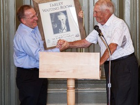 Matt Janes, left, president of the North America Railway Hall of Fame, shakes hands with Bob Farley on Sunday at the Canada Southern railway station after the historic building's ladies waiting room was named in the retired St. Thomas physician's honour for his ongoing support of CASO restoration. The waiting room is one of two ground floor public spaces.