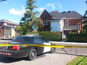 OPP officers guard the home of an Arnprior woman, Pamela Mimnagh, 55, who was run down and killed on Thursday, Oct. 2, 2014. (DANIELLE BELL Ottawa Sun)