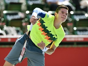 Milos Raonic serves against Denis Istomin during their men's singles quarterfinal match at the Japan Open in Tokyo on Friday, Oct. 3, 2014. (Kazuhiro Nogi/AFP)