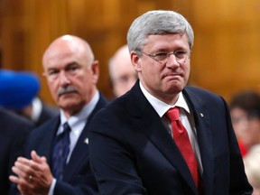 Canada's Prime Minister Stephen Harper receives a standing ovation before outlining his government's plan to participate in a military campaign against Islamic State militants, in the House of Commons on Parliament Hill in Ottawa October 3, 2014. Canadian fighter jets will take part in U.S.-led air strikes against Islamic State militants operating in Iraq for up to six months, Harper said on Friday.  REUTERS/Chris Wattie