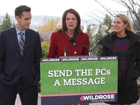 Wildrose leader Danielle Smith, flanked by Wildrose MLA Rob Anderson and candidate Kathy Macdonald challenge the Alberta PCs in Calgary, Alta., on Friday October 3, 2014. Mike Drew/Calgary Sun/QMI Agency