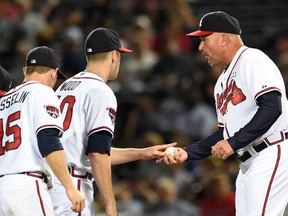 Atlanta Braves manager Fredi Gonzalez (33) takes the ball from starting pitcher Alex Wood (40) to  change pitchers against the Washington Nationals during the seventh inning at Turner Field on Sep 17, 2014 in Atlanta, GA, USA. (Dale Zanine/USA TODAY Sports)