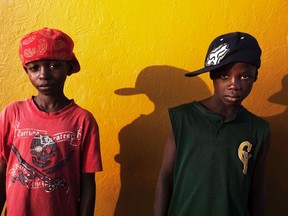 Komba Nyanku, 12, who wants to become a lawyer, and his friend, Abdoulaye Marrah, 12, who dreams of being a pilot, pose for a portrait in the town of Koidu in eastern Sierra Leone April 21, 2012. (REUTERS file photo/Finbarr O'Reilly)