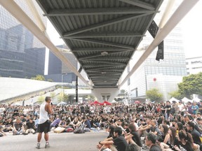 Pro-democracy protesters attend a talk under a foot bridge as thousands block a main road to the financial Central district in Hong Kong on Thursday. Sarnia native Vici Egan, now living in Hong Kong, is impressed by these well behaved protesters. (Bobby Yip/Reuters)