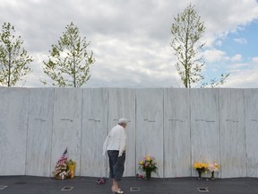 A woman looks at flowers at the Flight 93 National Memorial ahead of the 11th anniversary of the 9/11 attacks in Shanksville, Pennsylvania, on September 10, 2012. (AFP PHOTO/Mandel NGAN/POOL)