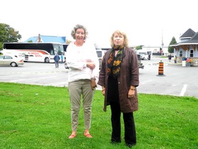 Margot Miller and Blaise DeLong stand in front of the boat lines parking lot in Rockport with its buses.