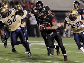 Running back Jonathan Williams #23 of the Ottawa Redblacks rushes past defensive tackle Bryant Turner Jr. #92 and safety Teague Sherman #27 of the Winnipeg Blue Bombers to score a touchdown on the rush during a CFL game at TD Place Stadium on October 3, 2014 in Ottawa, Ontario, Canada.  Jana Chytilova/Freestyle Photography/Getty Images/AFP