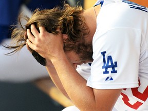 Los Angeles Dodgers starting pitcher Clayton Kershaw reacts in the dugout after being pulled in Game 1 of the National League Division Series against the St. Louis Cardinals at Dodgers Stadium in Los Angeles, Oct. 3, 2014. (JAYNE KAMON-ONCEA/USA Today)