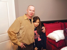 JOHN LAPPA/THE SUDBURY STAR
Robert Morneau hugs his daughter, Chelsea, 11, in her new furnished room at the family's new home.