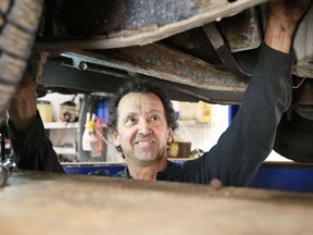 In this file photo, Kevin Forsythe of Straightline Auto on Lorne Street works on a car. He admits the city's bad roads are good for business. (Gino Donato/The Sudbury Star)
