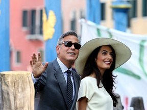 George Clooney and his wife Amal Alamuddin arrive at Venice city hall for a civil ceremony to formalize their wedding in Venice Sept. 29, 2014. REUTERS/Alessandro Bianchi