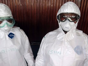 The names of trainee health workers are seen written on their protective suits at a World Health Organization (WHO) training session in Freetown, Sierra Leone, September 30, 2014.  REUTERS/Umaru Fofana