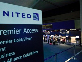 People are seen at the United Airlines terminal at Newark International Airport in New Jersey, July 22, 2014. REUTERS/Eduardo Munoz