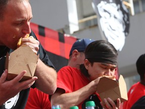 Joey, "Jaws" Chestnut the No. 1 World ranked, left, and Matt "The Megatoad" Stonie, the No. 2 ranked eater in the world compete on Oct. 4, 2014 in the 5th Annual World Poutine Eating Championship in Yonge Dundas Square. Stonie was declared he winner. (Veronica Henri/Toronto Sun)