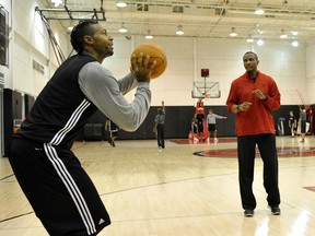 Raptors’ Dwane Casey (right) and forward James Johnson, seen here in 2011, are back together and better than ever. The two had a falling out three seasons ago. (Reuters)