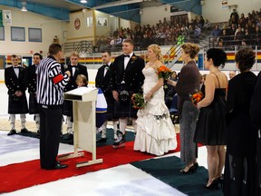 Padre Wayne Swallows officiates - in a referee's uniform - the wedding of Andrew McCracken and well-known Stirling hockey player Kelly Sage at centre ice in the Stirling arena Saturday.