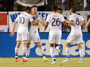 Los Angeles Galaxy forward Robbie Keane (7) and Los Angeles Galaxy forward Landon Donovan (10) celebrate after he scores a goal against Toronto FC during the first half at StubHub Center on Oct 4, 2014 in Carson, CA, USA. (Kelvin KuoUSA TODAY Sports)