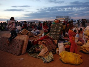 Syrian Kurdish refugees wait for transportation after crossing into Turkey, near the southeastern Turkish town of Suruc in Sanliurfa province Sept. 30, 2014. REUTERS/Murad Sezer